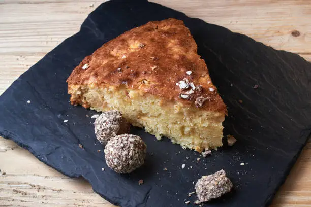 Photo of Delicious fresh baked piece of apple pie on shale board