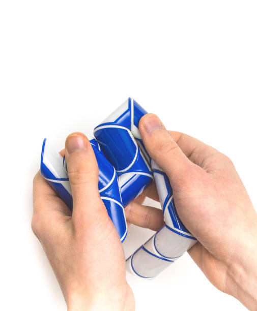 istock Puzzle snake toy in hands 938243144