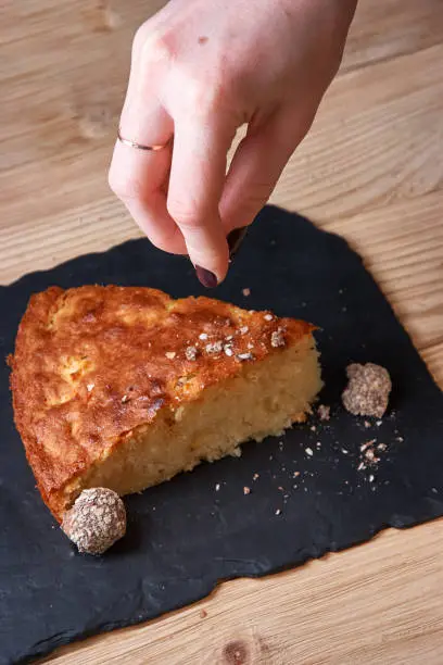 Photo of Delicious fresh baked piece of apple pie on shale board the hand boils chocolate