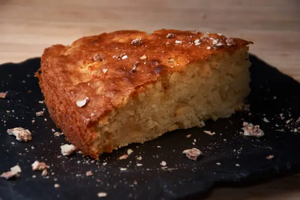 Photo of Delicious fresh baked piece of apple pie on shale board