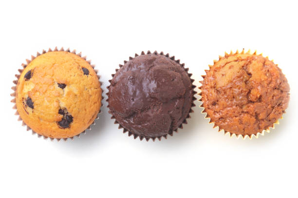 istock Assorted with Delicious homemade cupcakes with raisins and chocolate isolated on white background. Muffins. Top view 938243730