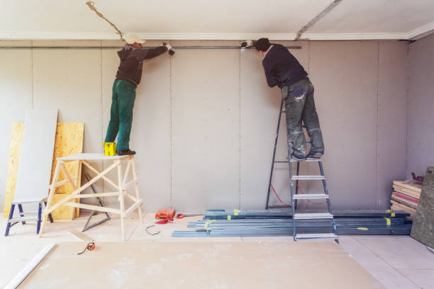 istock Workers are installing plasterboard drywall for gypsum walls in apartment is under construction, remodeling, renovation, extension, restoration and reconstruction. 938245798