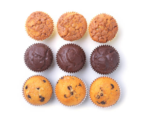 istock Assorted with Delicious homemade cupcakes with raisins and chocolate isolated on white background. Muffins. Top view 938245848