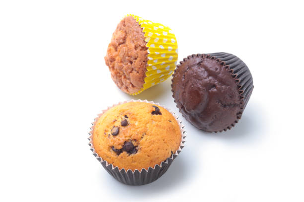 istock Assorted with Delicious homemade cupcakes with raisins and chocolate isolated on white background. Muffins. Top view 938245952