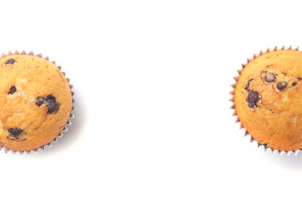 istock Assorted with Delicious homemade cupcakes with raisins and chocolate isolated on white background. Muffins. Top view. Copy space 938246000