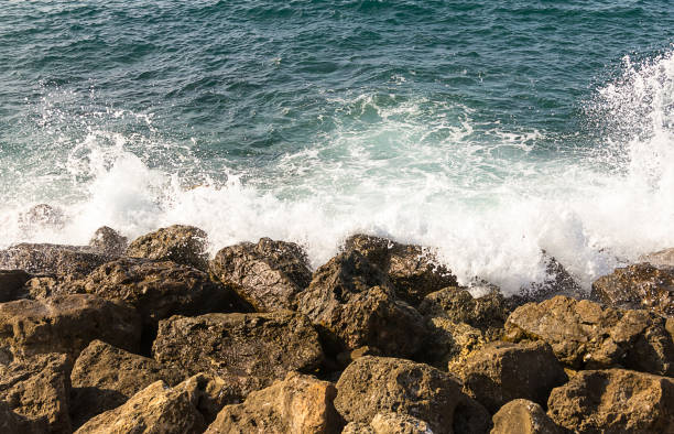 istock Azure sea white wave is broken about the shore brown stones greece crit 938247284