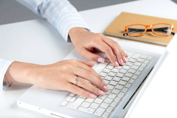 istock Female office worker typing on the keyboard 938247332