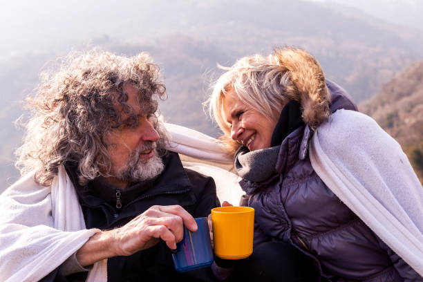 istock beautiful mature couple relaxing and drinking hot coffee 938254588