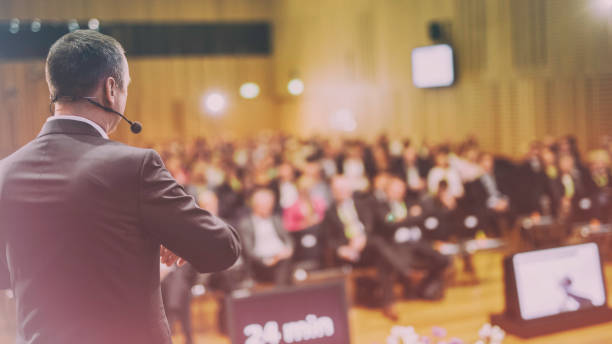 istock Rear view of a motivational coach giving a speech 938255142