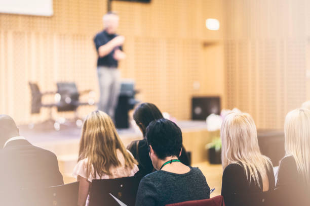 istock Audience listening to lecturer on stage 938255896