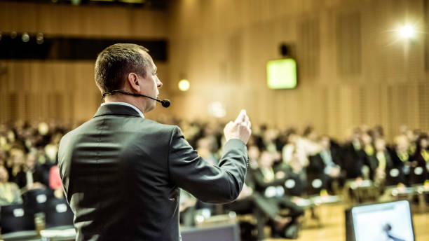 istock Businessman givng lecture at a full conference hall 938257780
