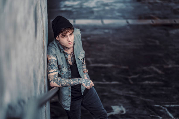 istock Young man sitting on the street 938259268