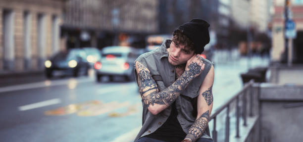 Young man sitting on the street.