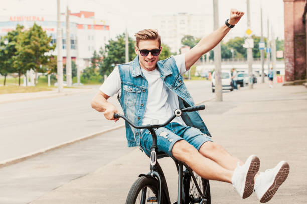 istock Handsome hipster enjoying city ride by bicycle. 938276066
