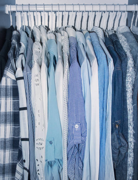 istock Blue women's clothes are hanging in the wardrobe. 938276246