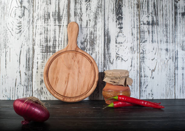istock Round cutting board wooden background 938280346