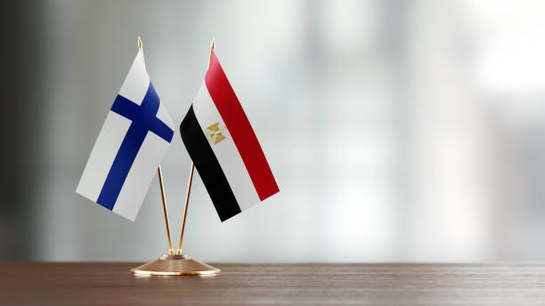 istock Finnish And Egyptian Flag Pair On A Desk Over Defocused Background 938285804