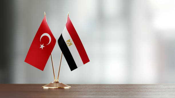 istock Turkish And Egyptian Flag Pair On A Desk Over Defocused Background 938285960