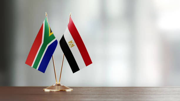 istock South African And Egyptian Flag Pair On A Desk Over Defocused Background 938286040