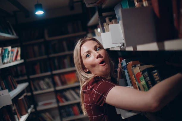 istock Young beautiful blond student girl with book 938288964