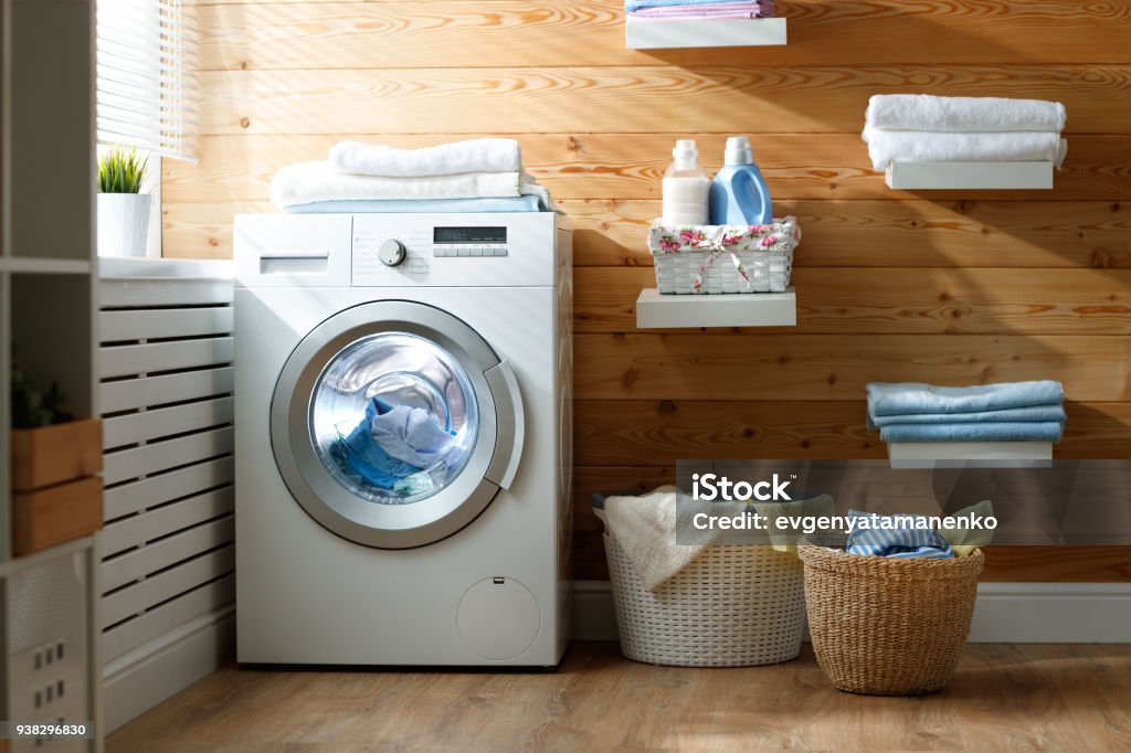 Interior of real laundry room with  washing machine at window at home Interior of a real laundry room with a washing machine at the window at home Dryer Stock Photo