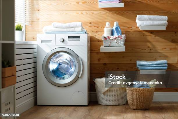 Interior Of Real Laundry Room With Washing Machine At Window At Home Stock Photo - Download Image Now
