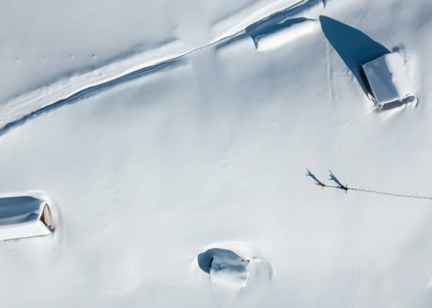 istock Log cabins covered in snow from above 938304984