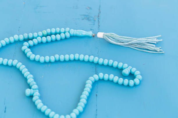 istock Muslim prayer beads beads on blue background. Copy space. 938308540