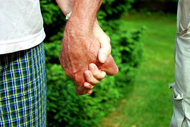 senior couple holding hands  beines stock pictures, royalty-free photos & images