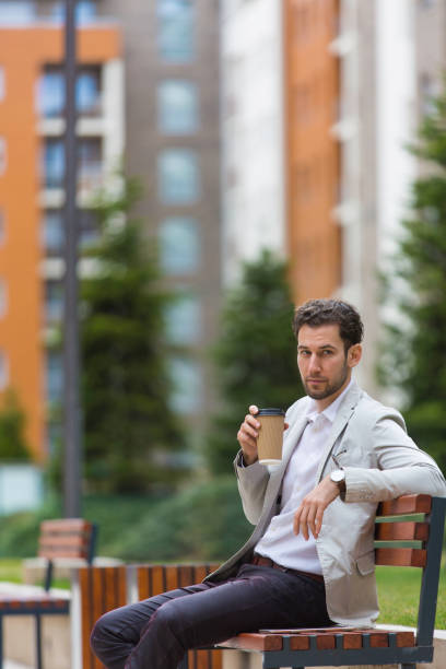 istock Handsome businessman having a coffee break outdoors 938311802