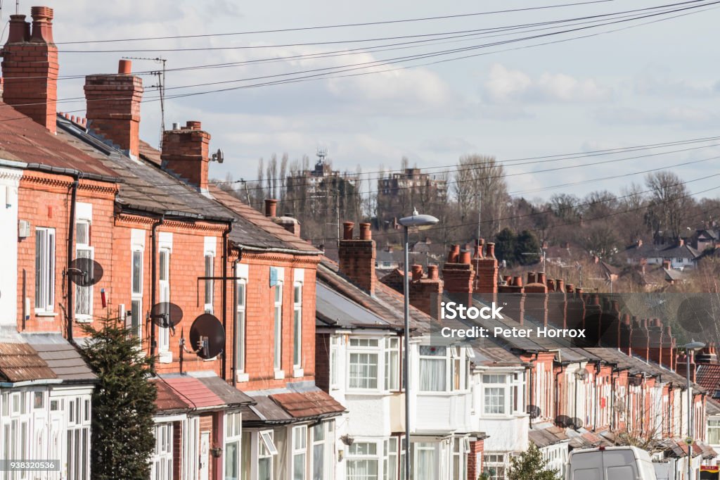 Row of terraced house roofs with chimney stacks Residential Building Stock Photo