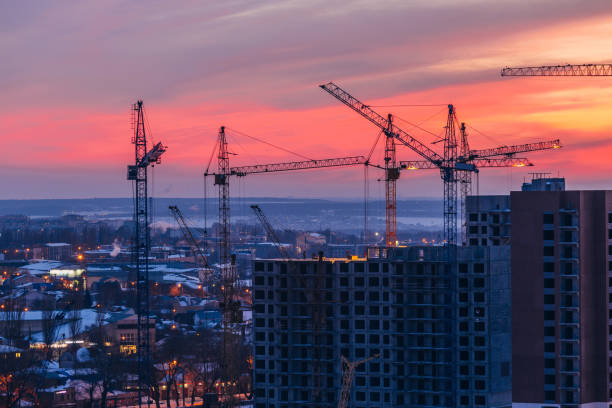 istock High-rise buildings construction site on crimson sunset sky background. Voronezh, Russia 938323444