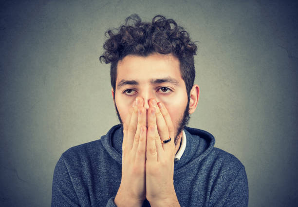 istock Sad man covering face in despair 938327490