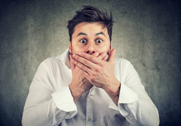 istock Scared man covering mouth in silence 938327584