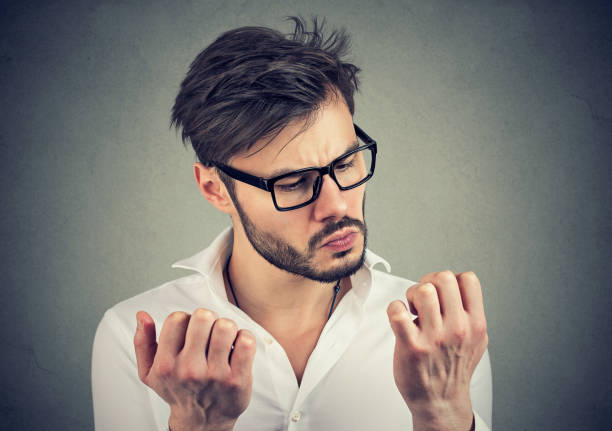 istock man with obsessive compulsive disorder exploring cleanliness of hands. 938329724