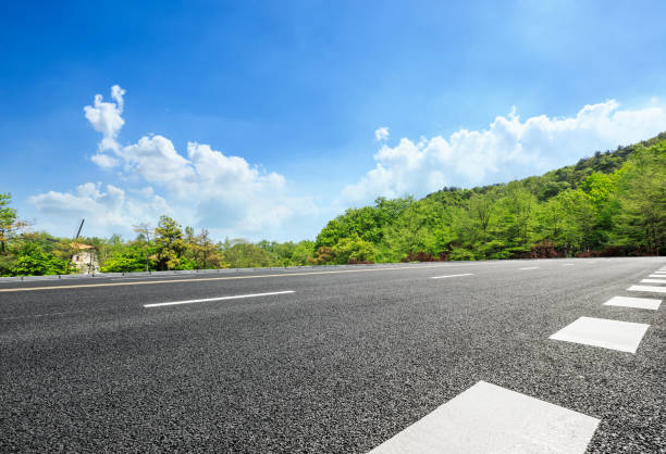 istock asphalt road and green forest with mountain landscape 938330328