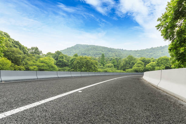 istock asphalt road and green forest with mountain landscape 938333082