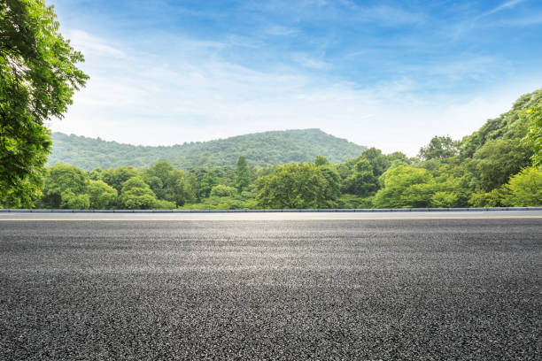 istock asphalt road and green forest with mountain landscape 938333086