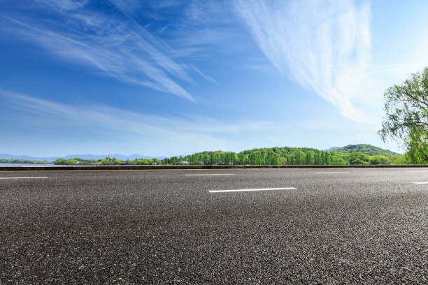 istock asphalt road and green forest with hill in summer 938335684
