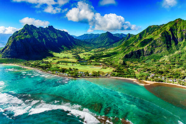 Aerial View of Kualoa area of Oahu Hawaii The beautiful and unique landscape of coastal Oahu, Hawaii and the Kualoa Ranch where Jurassic Park was filmed as shot from an altitude of about 1000 feet over the Pacific Ocean. oahu stock pictures, royalty-free photos & images