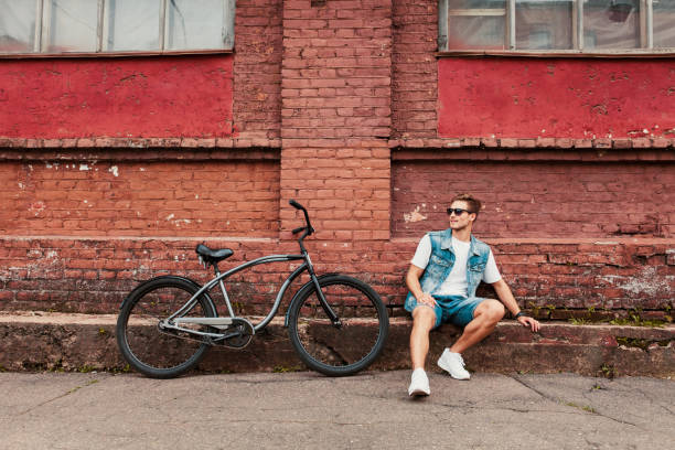 istock A young stylish hipster posing next to his bicycle. 938336132