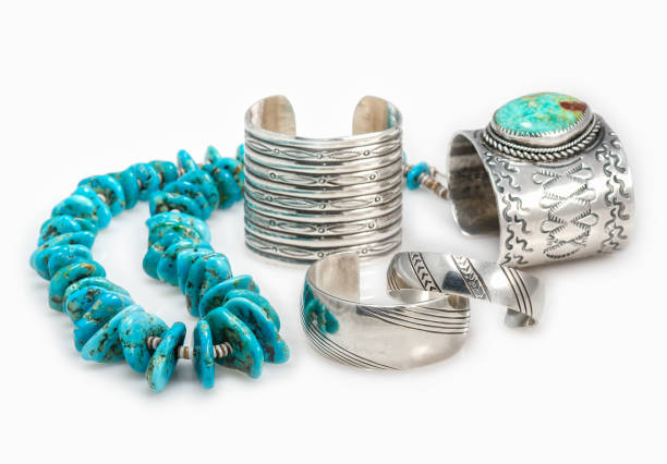 Collection of Sterling Silver Native American Bracelets with a Turquoise Nugget Necklace with shallow depth of field.