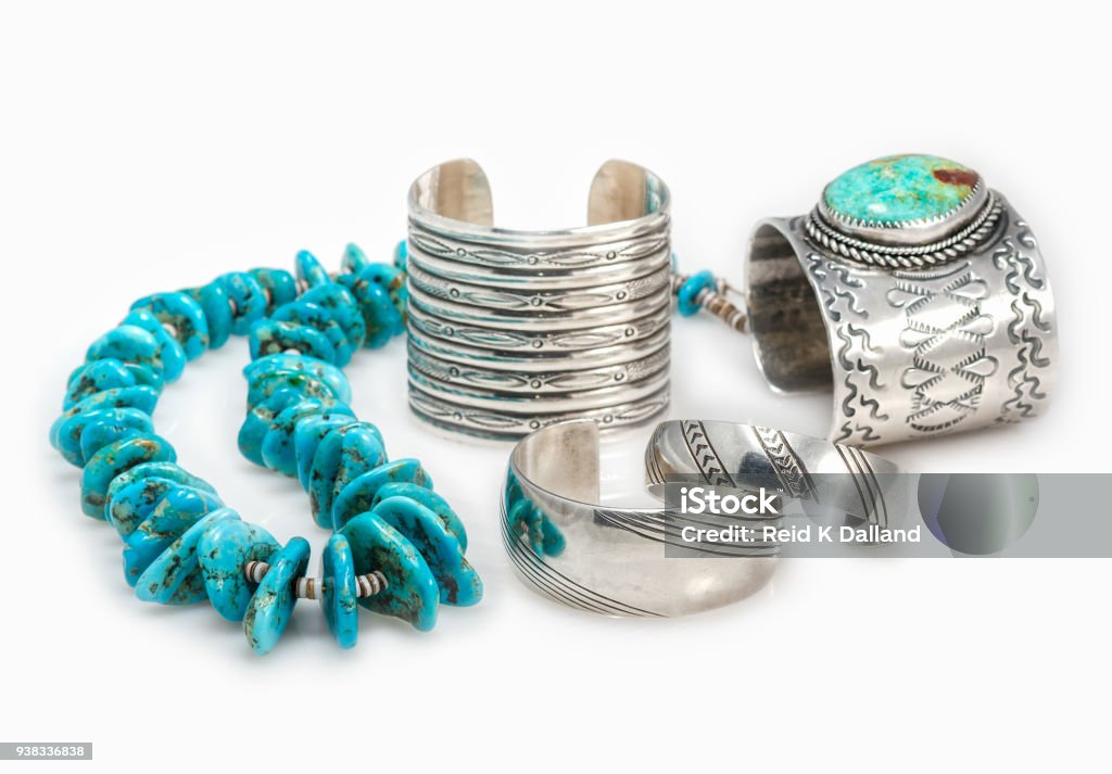 Native American Bracelets and Turquoise Necklace. Collection of Sterling Silver Native American Bracelets with a Turquoise Nugget Necklace with shallow depth of field. Jewelry Stock Photo