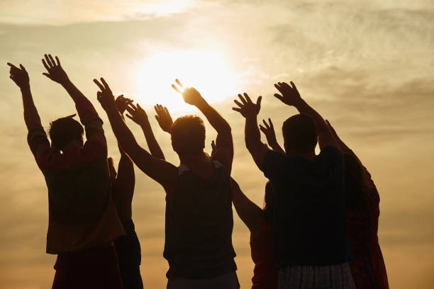 istock Hands up silhouette in sunny sky background. 938340438