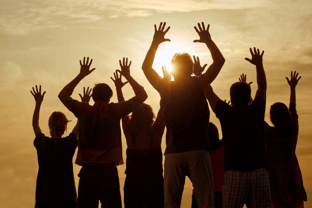 istock People raise hands up while live concert show, back view. 938340570