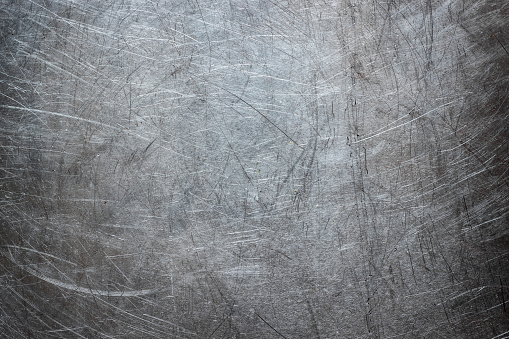 Texture of stainless steel wallpaper, background of metal with scuffs