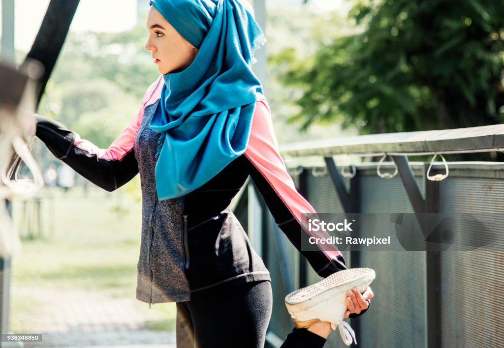 Islamic woman stretching after workout at the park Women Stock Photo