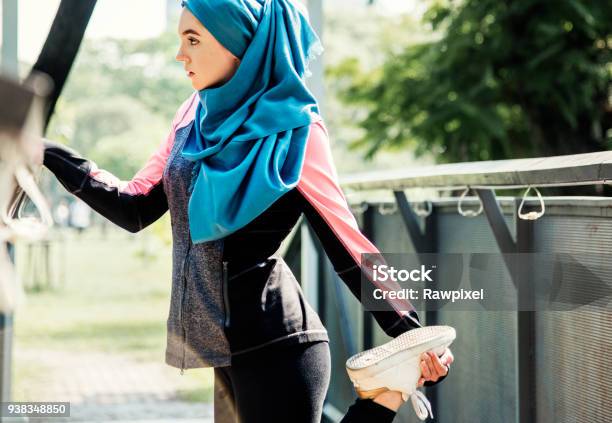 Islamic Woman Stretching After Workout At The Park Stock Photo - Download Image Now - Women, Exercising, Arabia