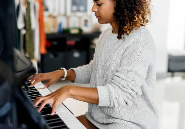 femme jouant d'un piano - songwriter photos et images de collection