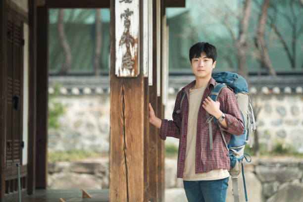 istock young man doing a backpacking trip in a Korean traditional house. 938349780